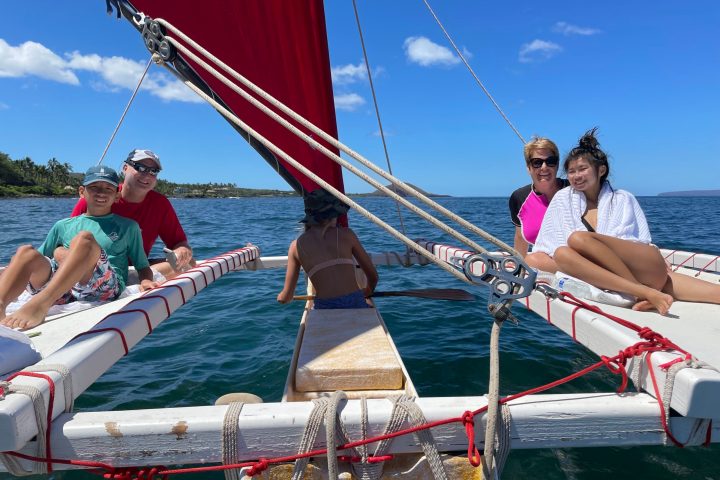 a group of people in a boat on a body of water